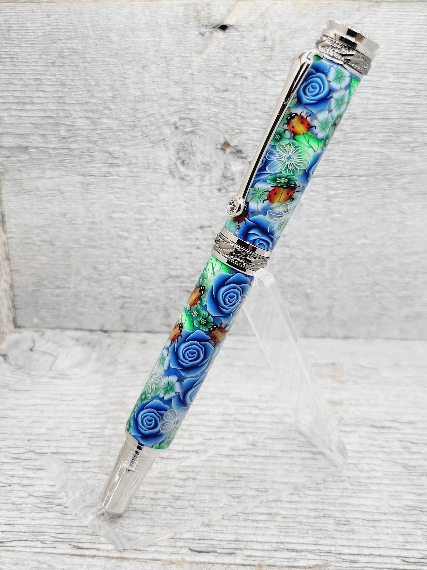 Jr Majestic Rollerball Pen with a Blue Rose/Lady Bug Polymer Clay Body