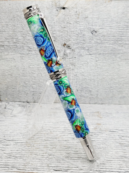 Jr Majestic Rollerball Pen with a Blue Rose/Lady Bug Polymer Clay Body